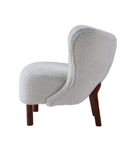White sherpa accent chair viewed from the side against a plain background