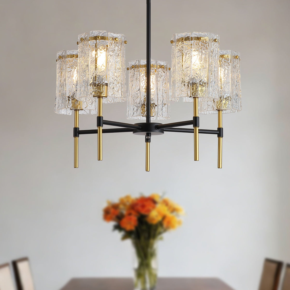Black and gold chandelier shown from the side against a plain background