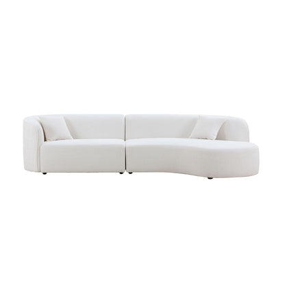 Curved sofa with chaise styled in a living room