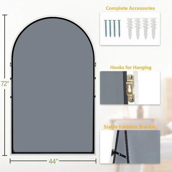 White arched floor mirror viewed at an angle against a plain background