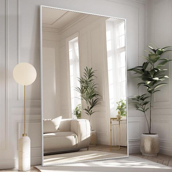 Oversized silver rectangular floor mirror shown in a room setting