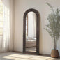 Arched solid wood floor mirror in a farmhouse living room