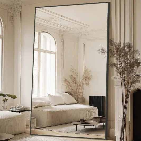 Rectangular black floor mirror in a bedroom