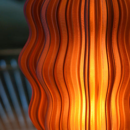 Cordless mini wavy lamp shown in a bedroom setting
