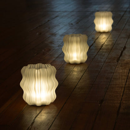 Cordless mini wavy lamp shown at an angle against a plain background