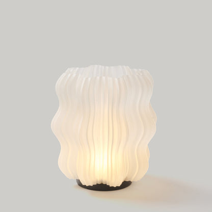 Cordless mini wavy lamp lit in a dim room