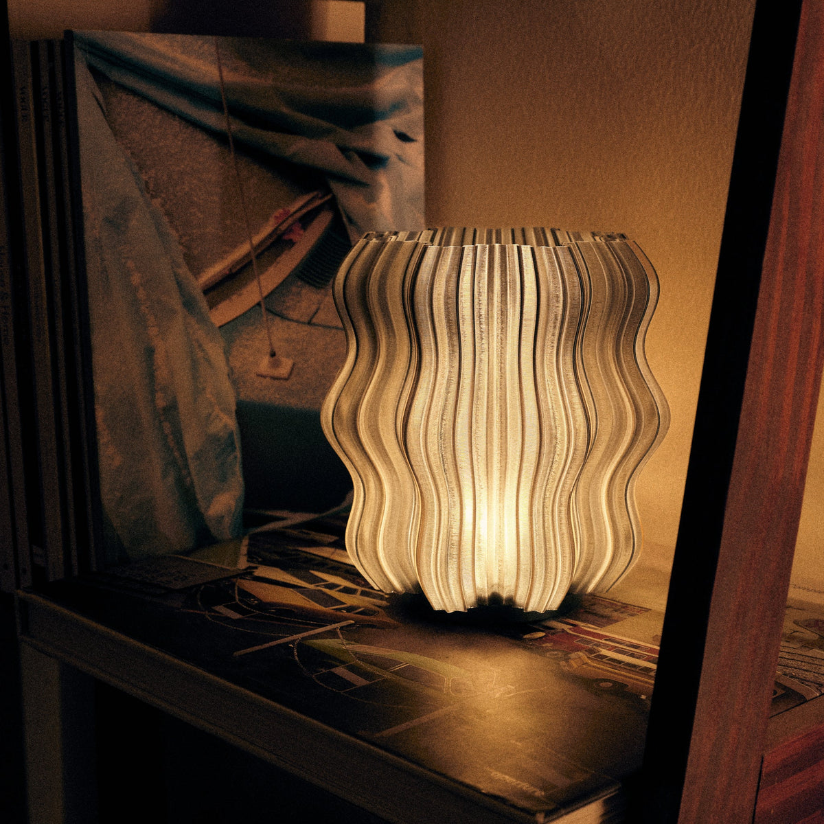 Cordless mini wavy lamp shown on a shelf