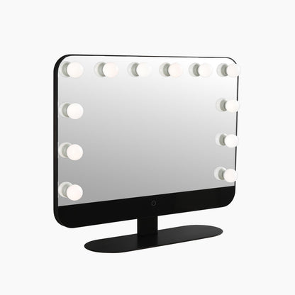 Matte black vanity mirror lit and viewed straight on against a plain background