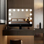 Hollywood vanity mirror with twelve bulbs shown on a dressing table