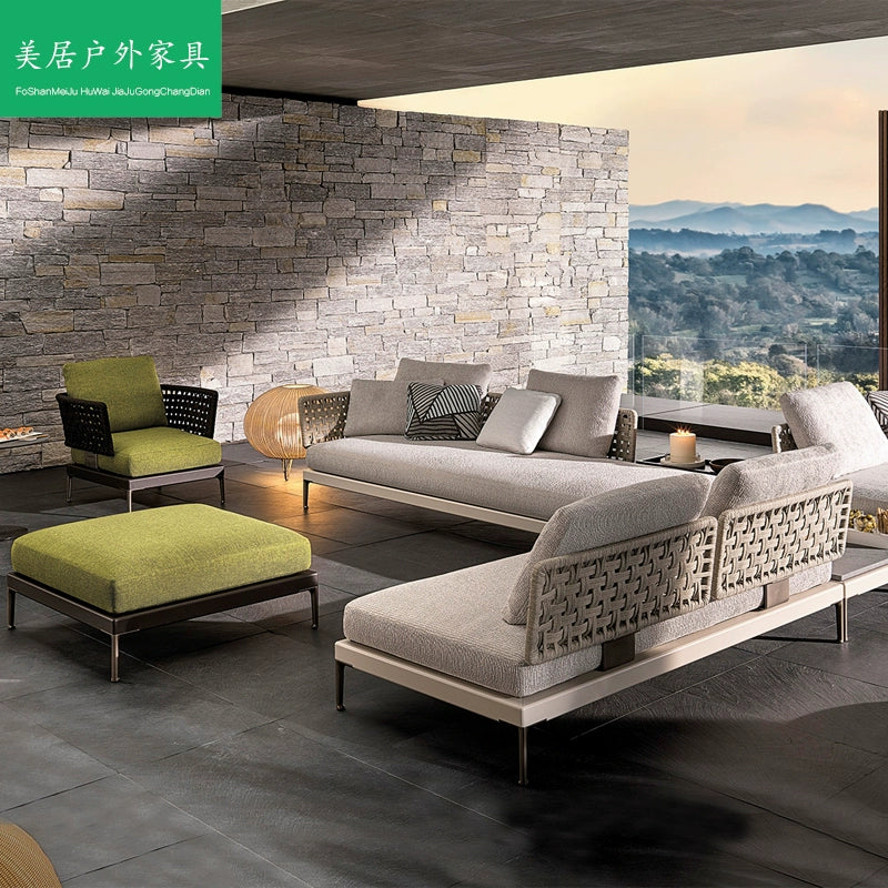 Outdoor rattan sofa arranged in garden seating area