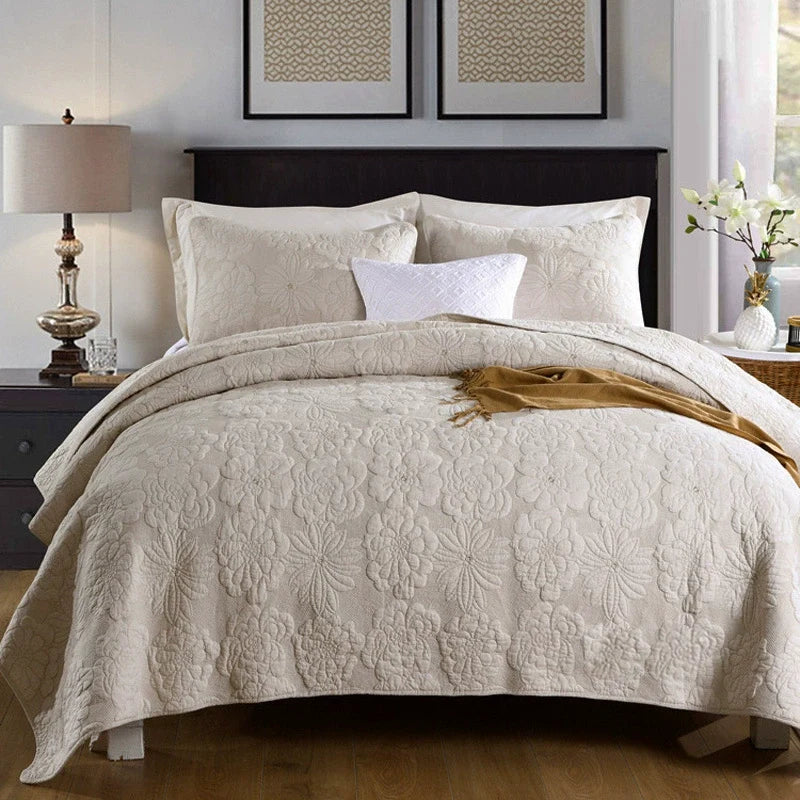 Cotton quilted bedspread set styled on a bed with two pillowcases