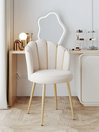 Makeup vanity chair beside dressing table