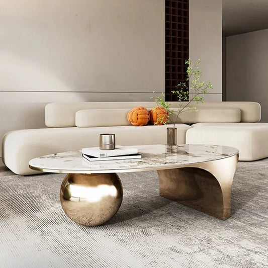 Oval marble-top coffee table on a metal base in a modern living room