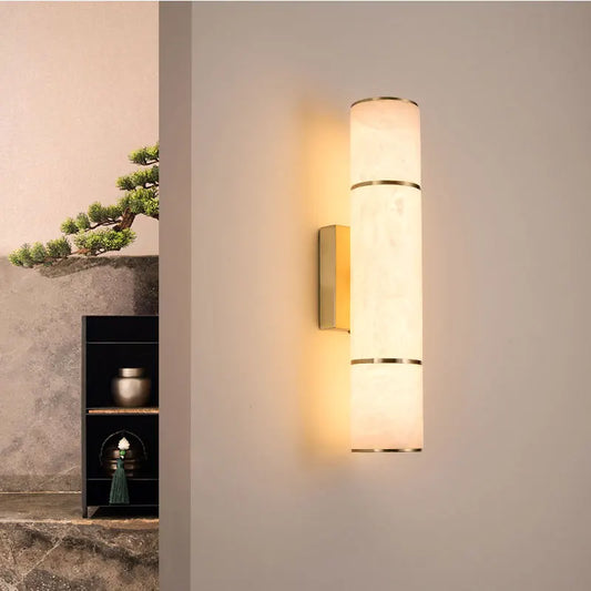 Marble and copper LED wall sconce mounted on wall