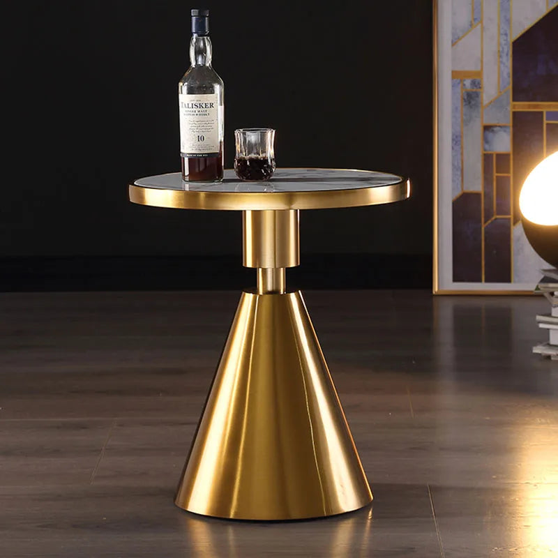 Round marble-top coffee table with stainless steel base in a living room setting