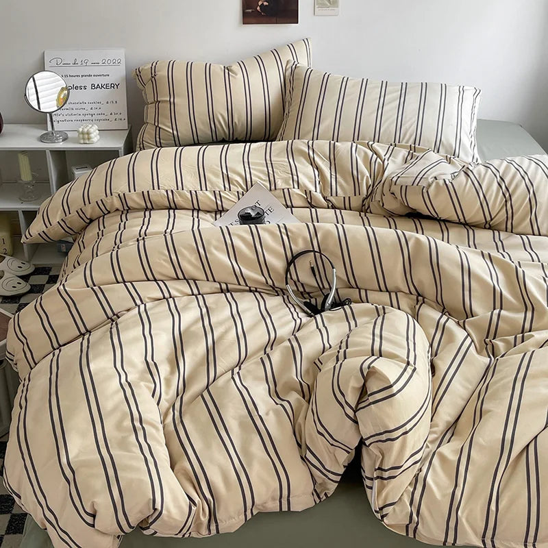 Striped duvet cover set styled on a bed with matching pillowcases