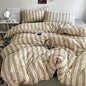 Striped duvet cover set styled on a bed with matching pillowcases