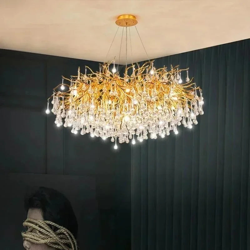 Crystal ceiling chandelier with branching gold arms and cut crystal drops over a dining table