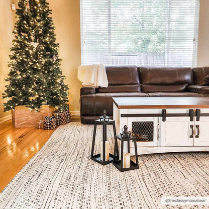 Cream and black hand woven wool rug shown in a room setting