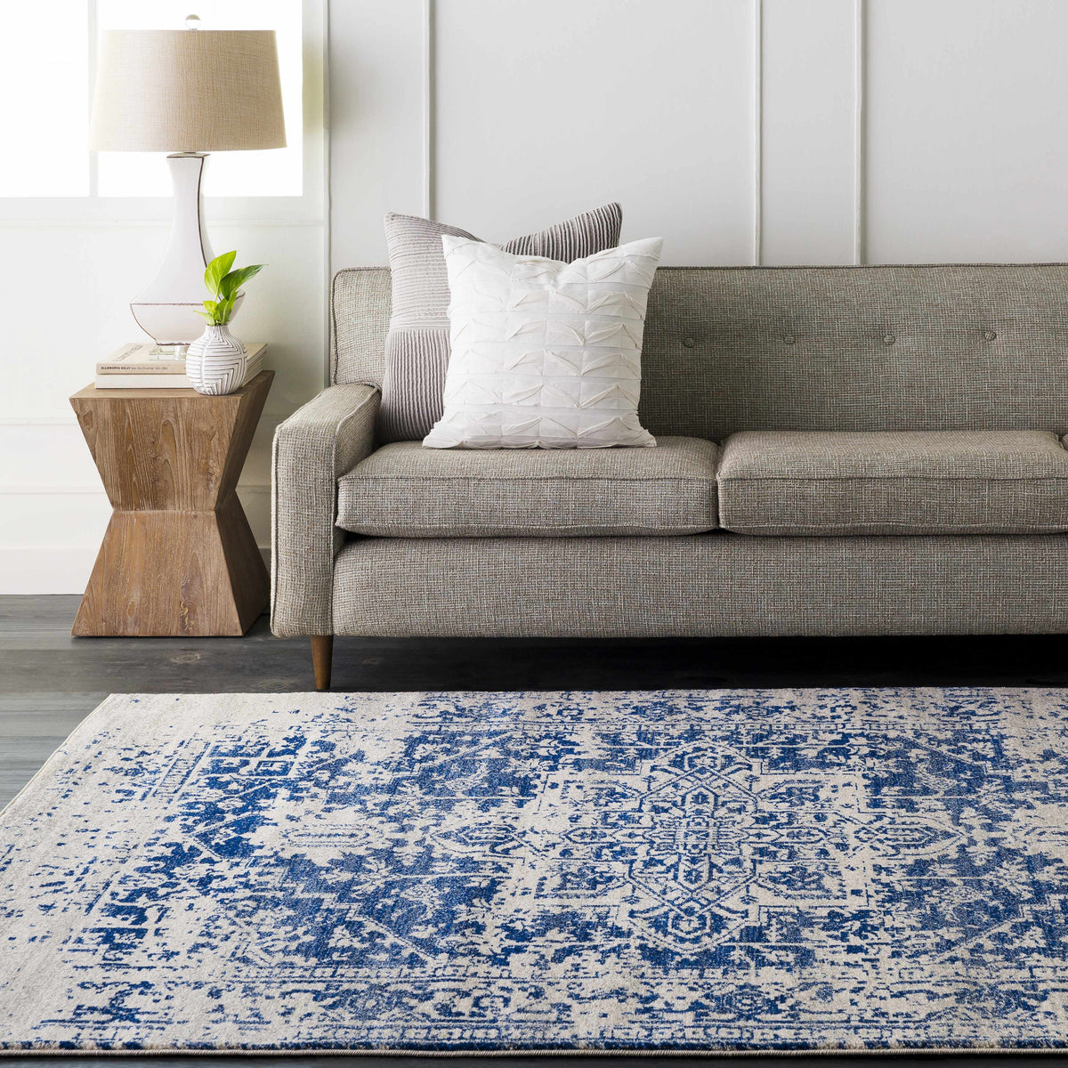 Navy patterned rug photographed flat against a plain background