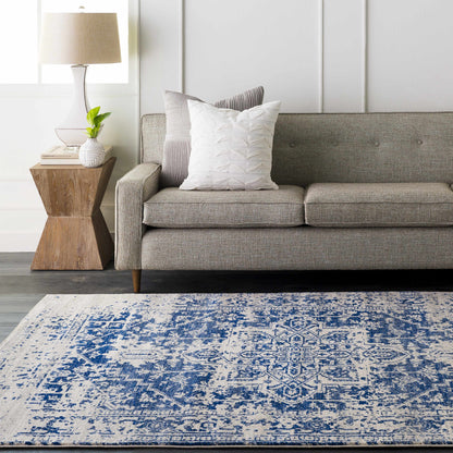 Navy patterned rug photographed flat against a plain background