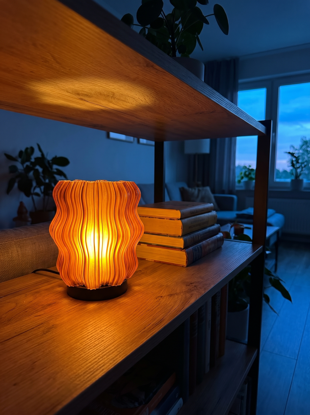 Cordless Mini Wavy Lamp lit at dusk on an open shelf casting a warm pool of light