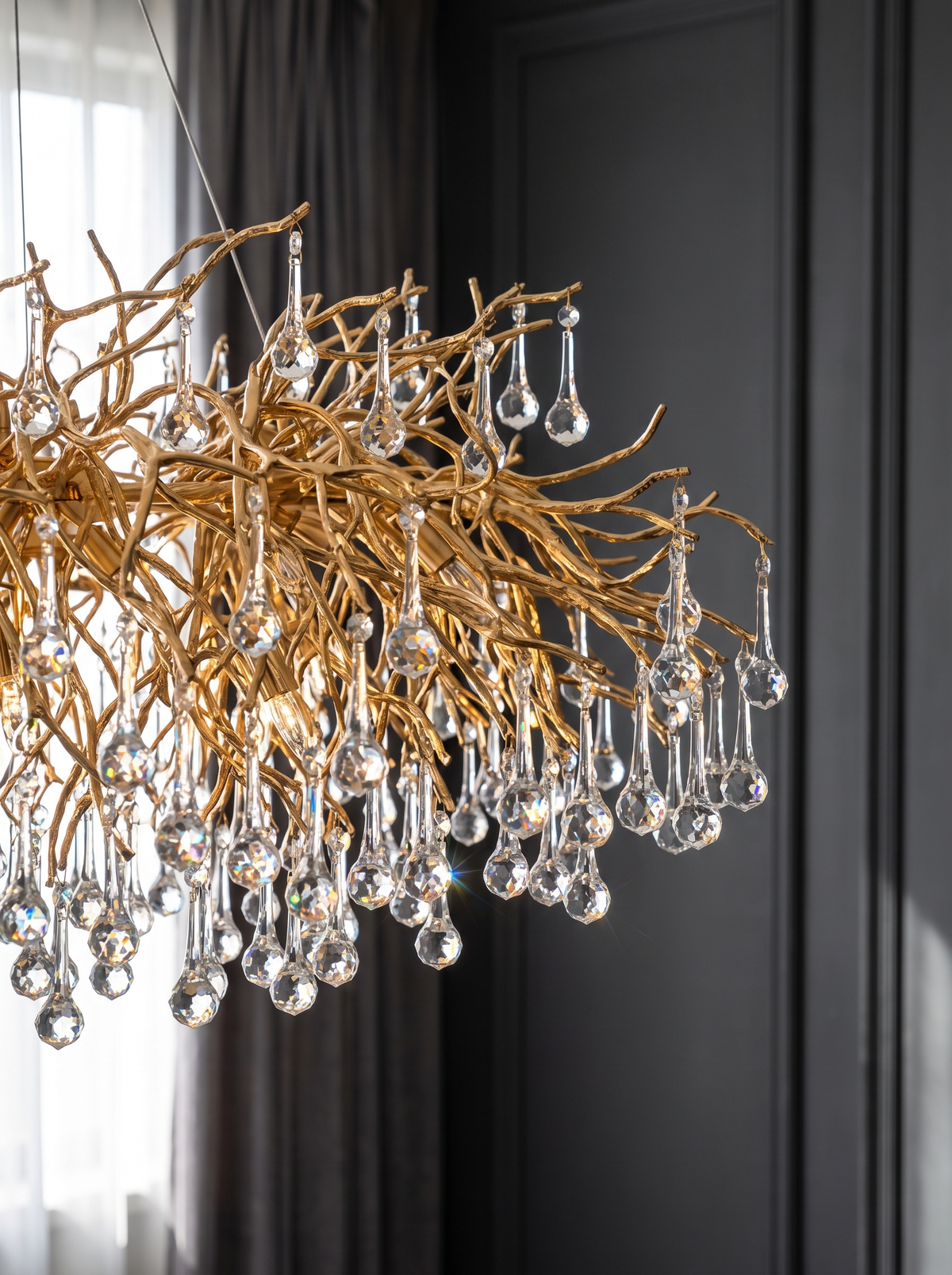 Close view of the branching gold arms and cut crystal drops of the crystal ceiling chandelier